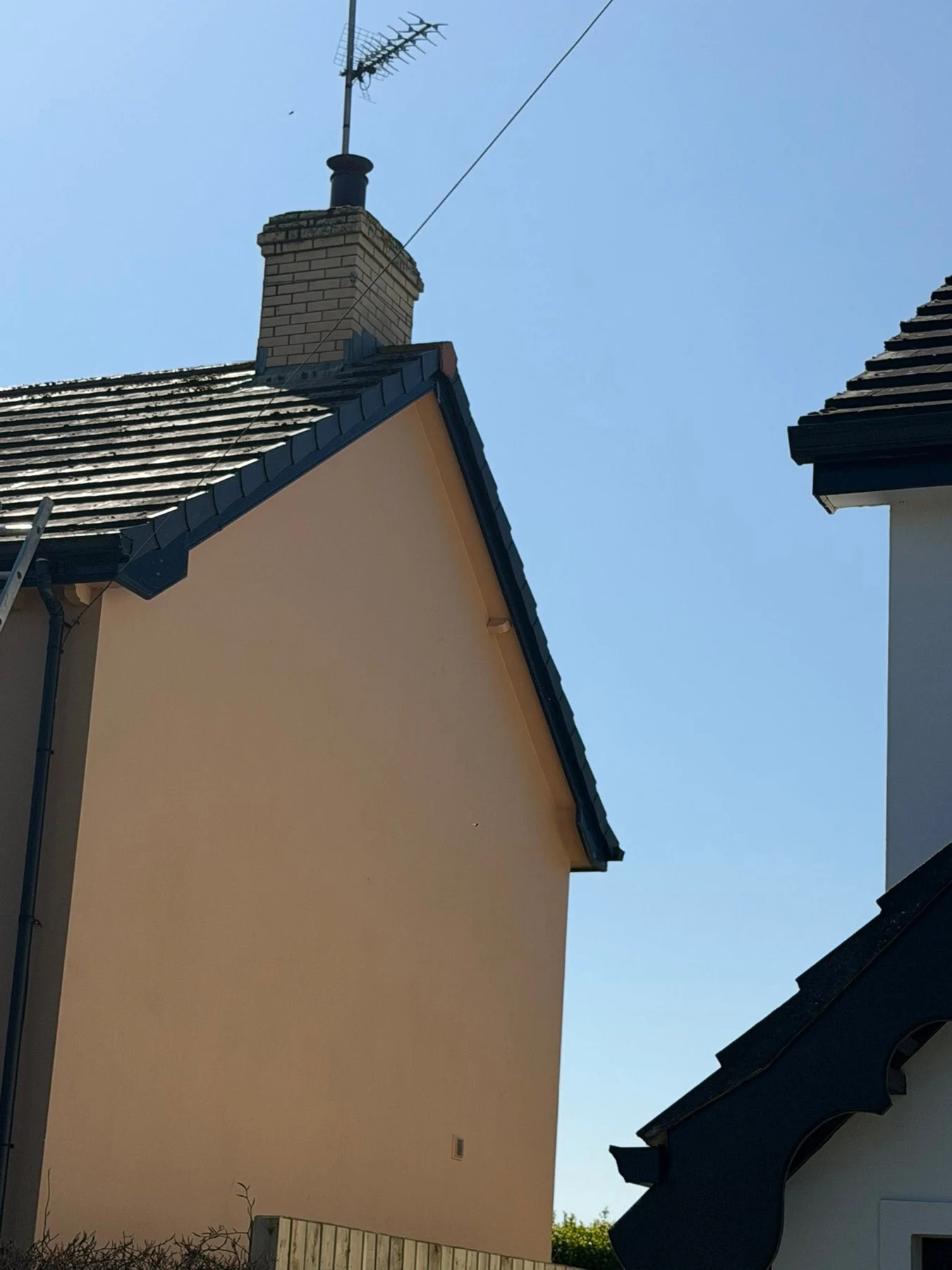 Dry verge fitted along the gable edge beside a chimney