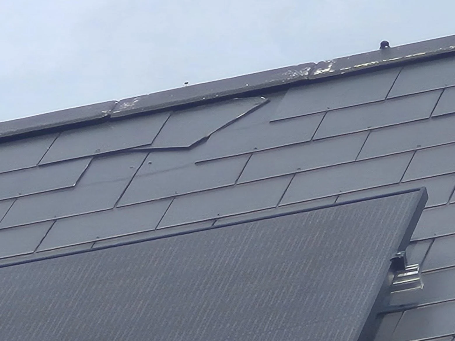 Slate roof repair above solar panels